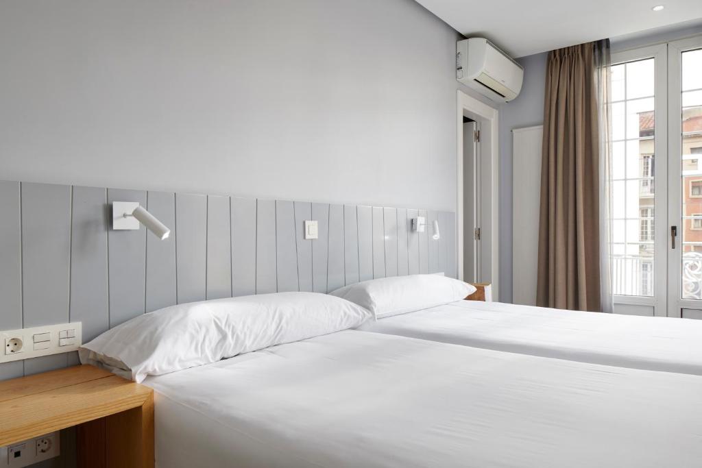 Postel nebo postele na pokoji v ubytování Hotel Avenida