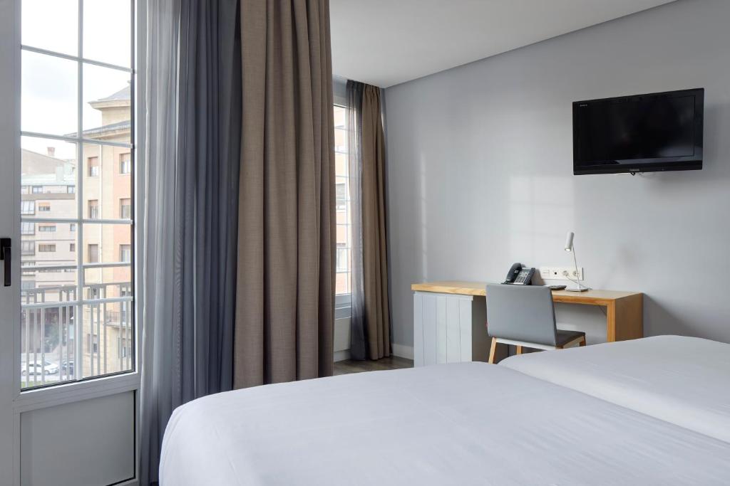 Postel nebo postele na pokoji v ubytování Hotel Avenida