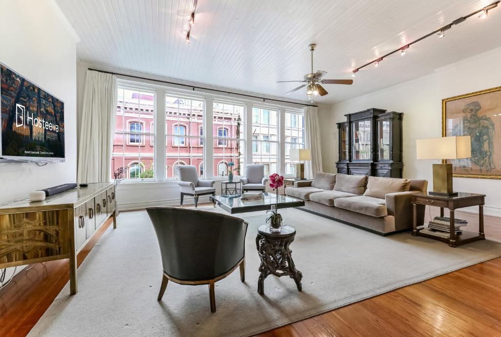 a living room with a couch and a table at City View Condo with Private Rooftop in New Orleans