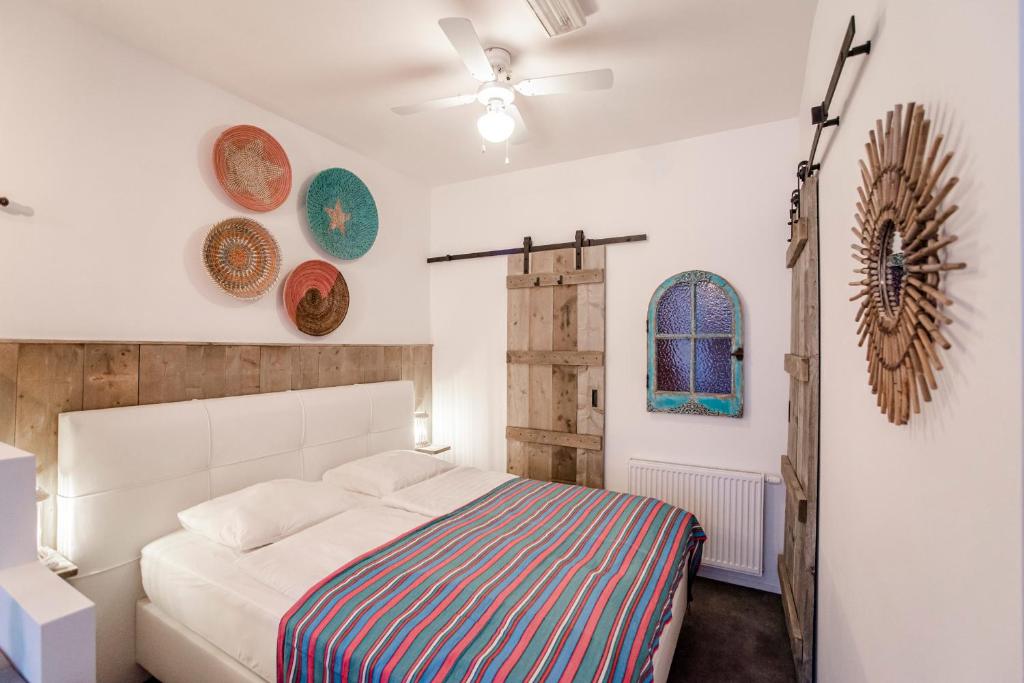 1 dormitorio con 1 cama y algunos platos en la pared en Beach Studio Boom, en Zandvoort