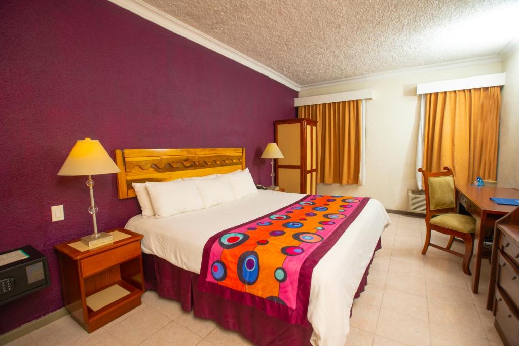 Postel nebo postele na pokoji v ubytování Le Plaza Hotel