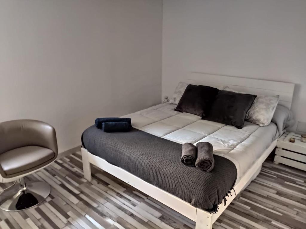 ein Bett mit zwei Schuhpaaren in einem Schlafzimmer in der Unterkunft Cerverahouse in Cervera de Buitrago