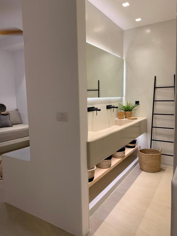 a bathroom with a sink and a mirror at Ios Art Suites in Ios Chora