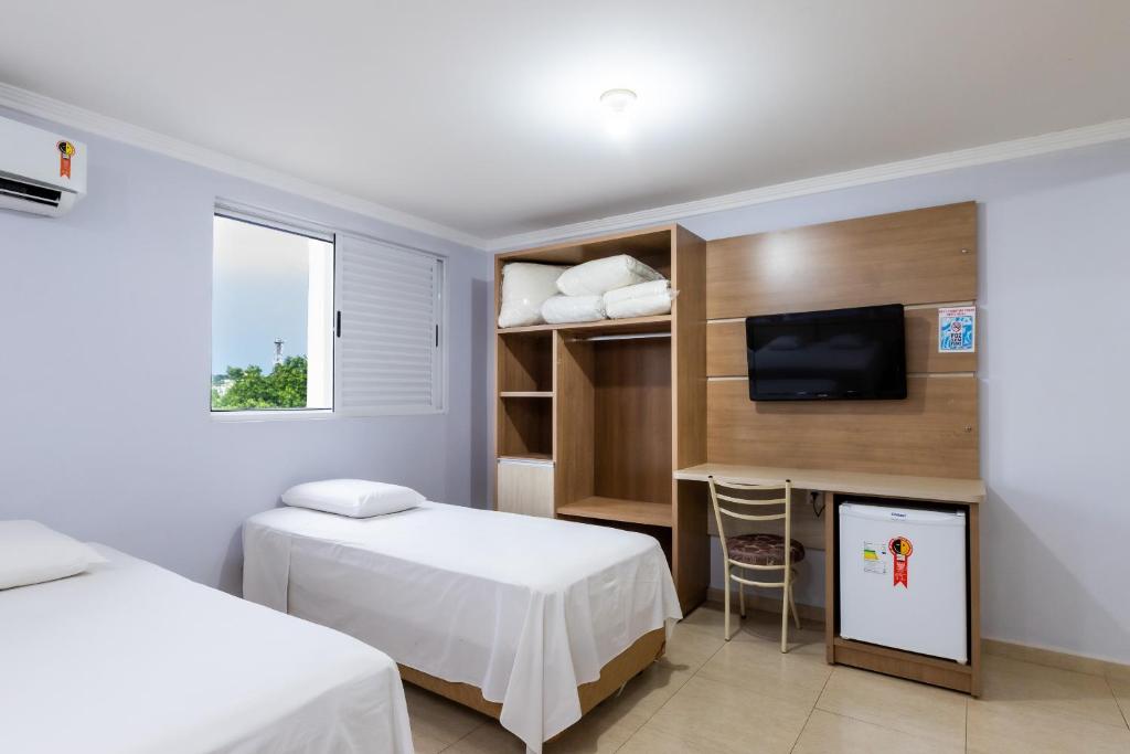 Postel nebo postele na pokoji v ubytování Hotel Baviera Iguassu