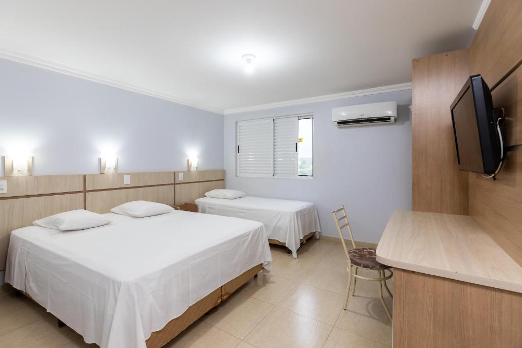 Postel nebo postele na pokoji v ubytování Hotel Baviera Iguassu