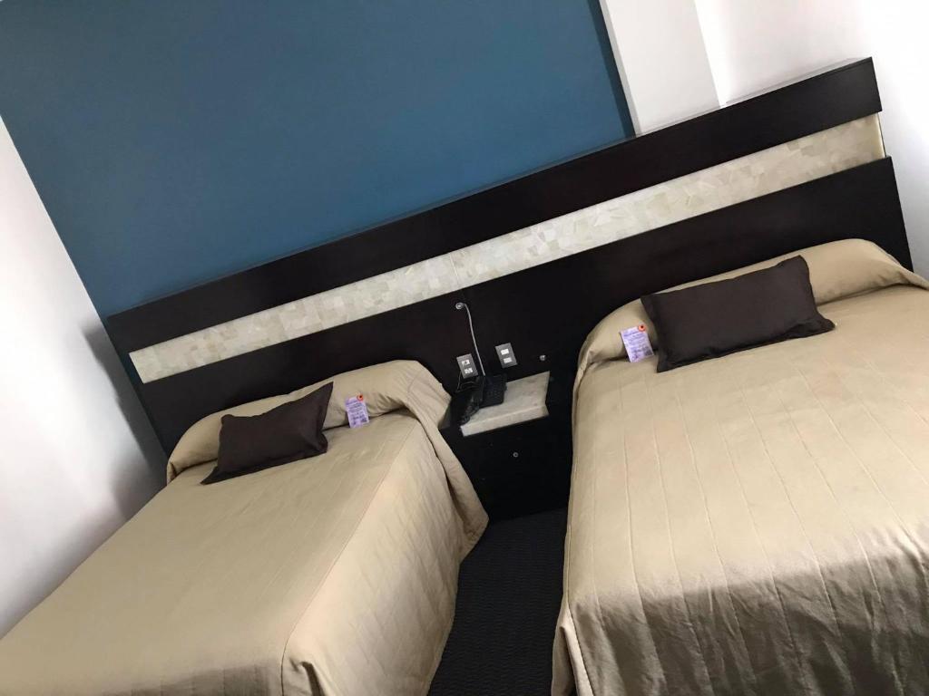 Postel nebo postele na pokoji v ubytování Hotel Real Rex