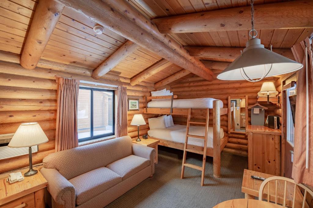 a living room with a bunk bed in a log cabin at Cowboy Village Resort in Jackson