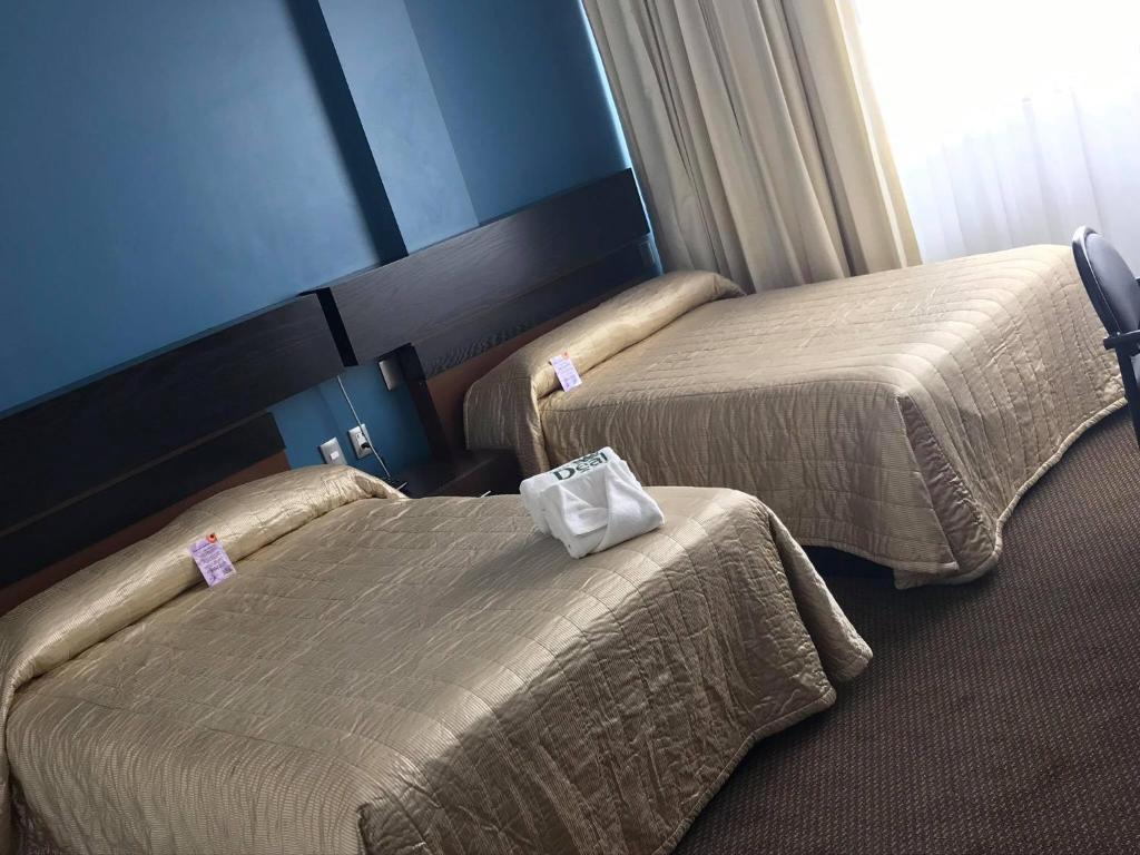 Postel nebo postele na pokoji v ubytování Hotel Real Rex