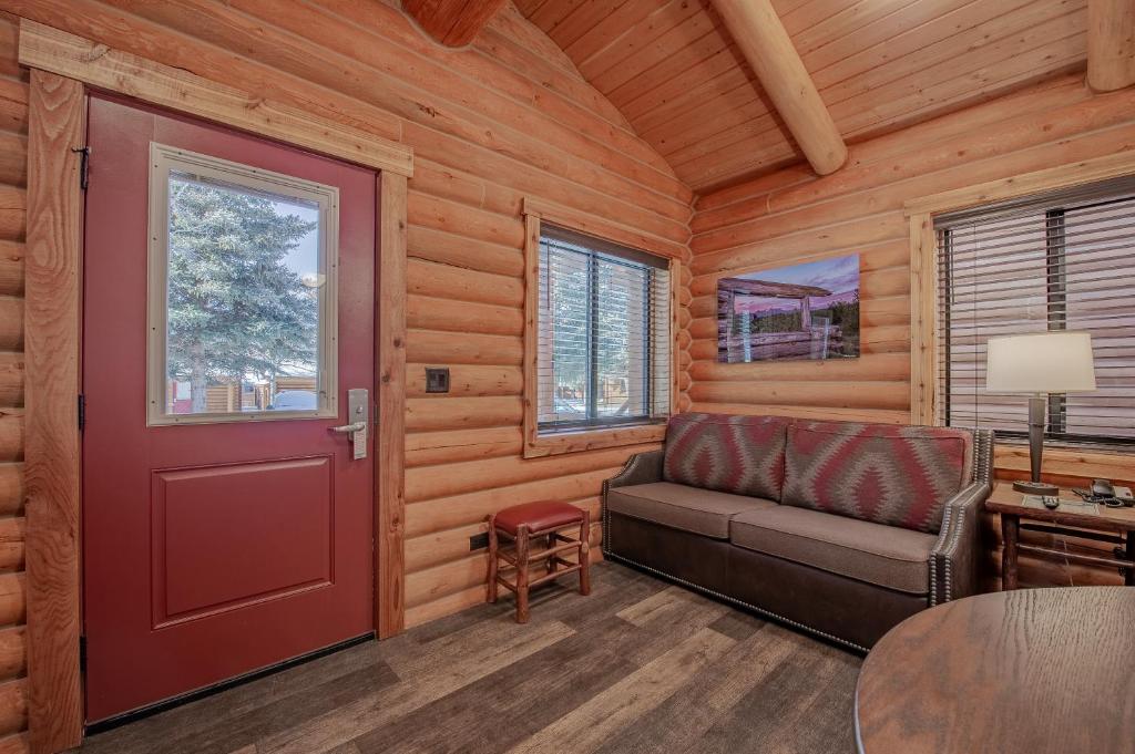 a living room with a couch and a red door at Cowboy Village Resort in Jackson