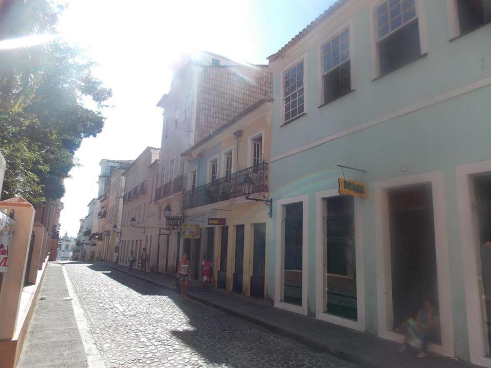 an empty street with buildings on the side at A meson Suites in Salvador