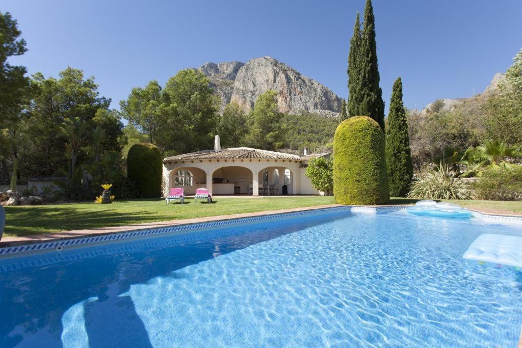 a large swimming pool in front of a house at Casa Ponoig in Polop