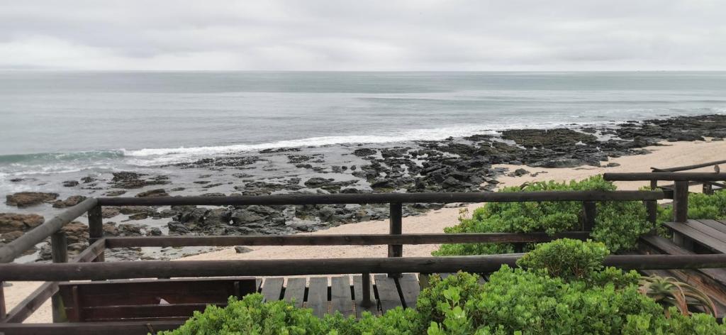 a view of the beach from a balcony at Anna's Place in Jeffreys Bay