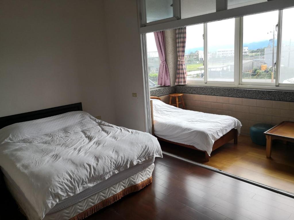 Postel nebo postele na pokoji v ubytování New Flower Homestay