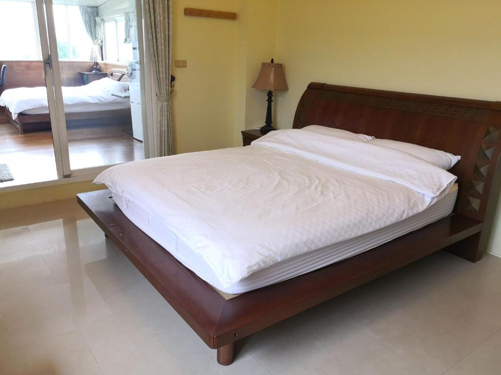 Postel nebo postele na pokoji v ubytování New Flower Homestay