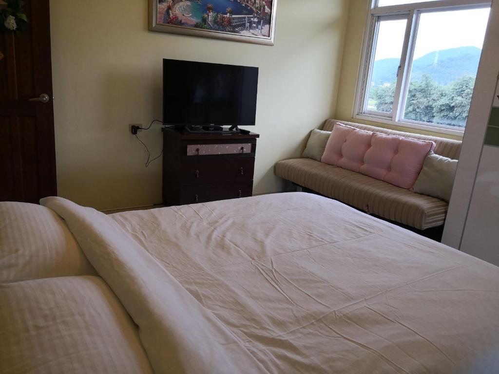 Postel nebo postele na pokoji v ubytování New Flower Homestay