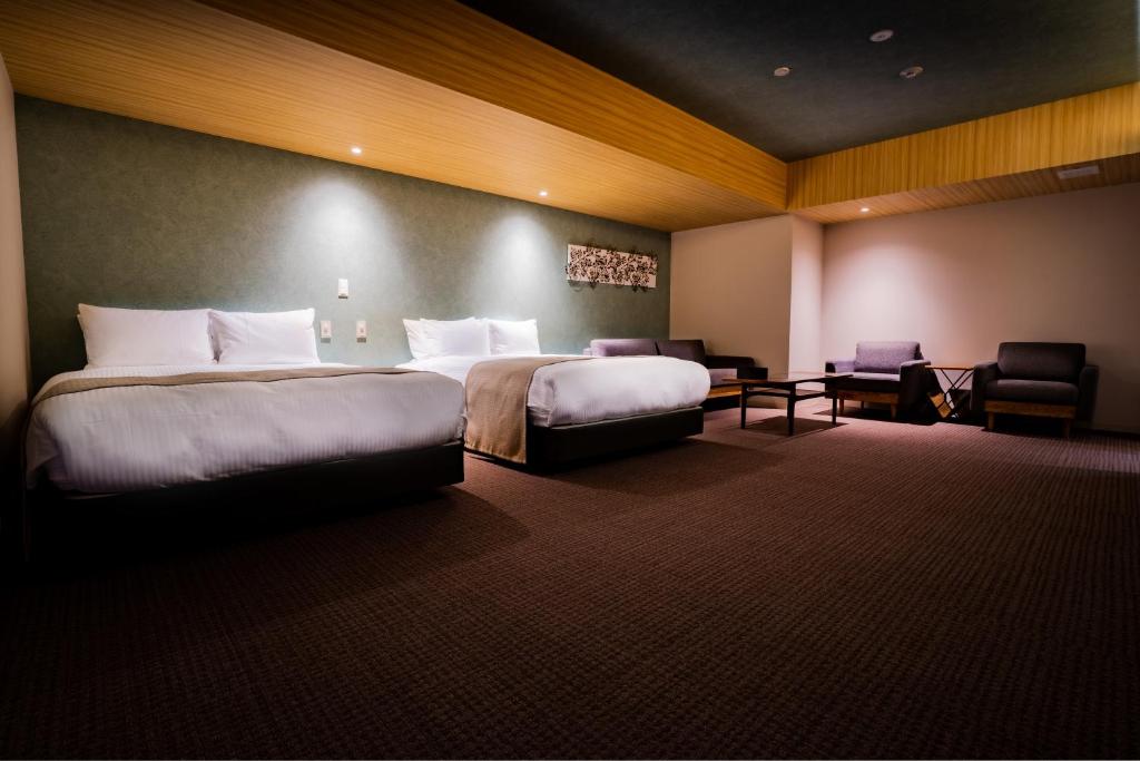 Postel nebo postele na pokoji v ubytování Randor Hotel Namba Osaka Suites