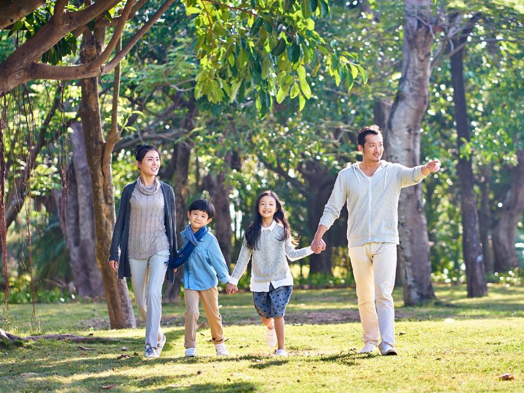 a family walking in a park holding hands at Shangri-La Far Eastern Tainan in Tainan
