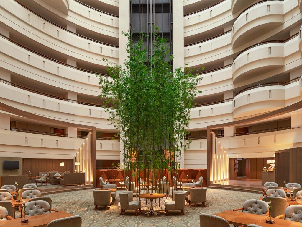 a rendering of a hotel lobby with tables and a tree at Shangri-La Far Eastern Tainan in Tainan
