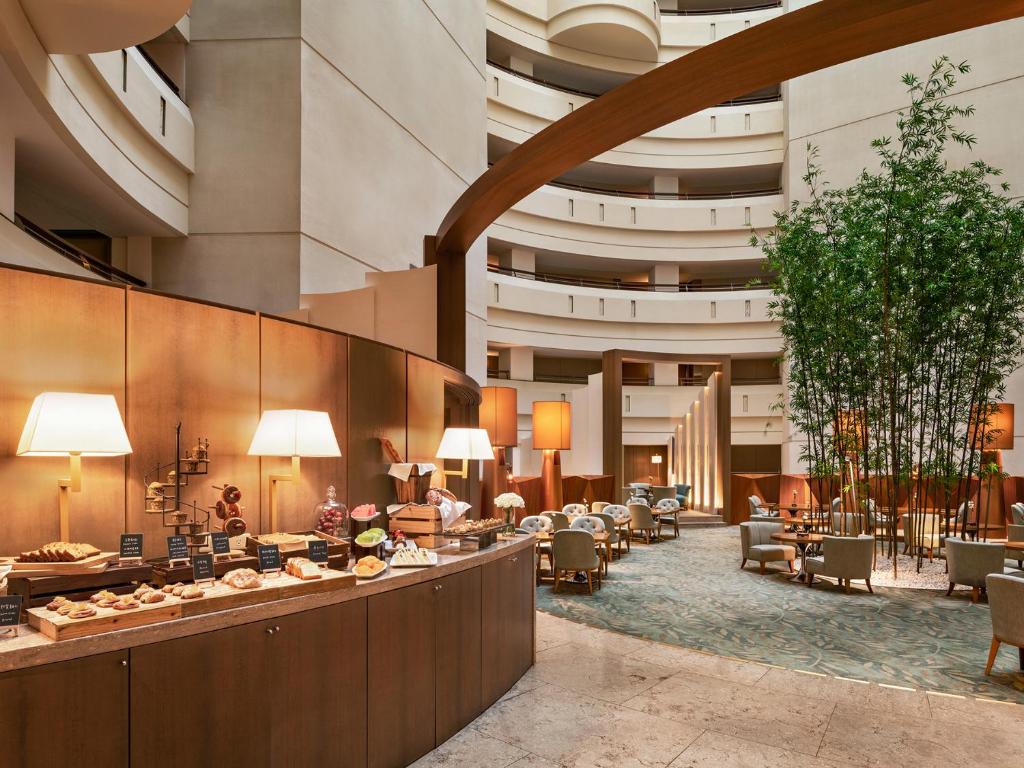 a lobby of a hotel with tables and chairs at Shangri-La Far Eastern Tainan in Tainan