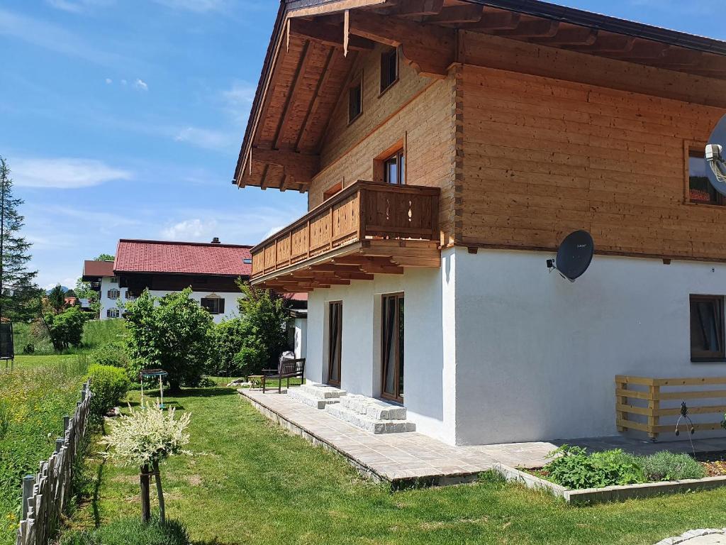 a house with a balcony on top of it at Chalet Weitsee in Reit im Winkl