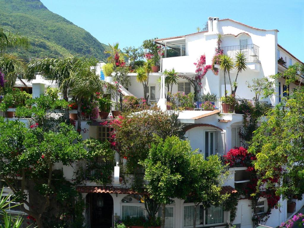 a white building with lots of plants on it at Hotel la Maggioressa in Ischia