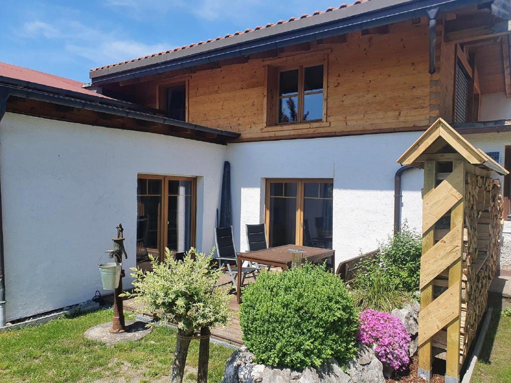 a house with a garden and a table in front of it at Ferienhaus Ulla in Reit im Winkl