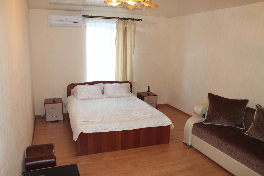 a small bedroom with a bed and a window at Elyzium Hotel Complex in Samara