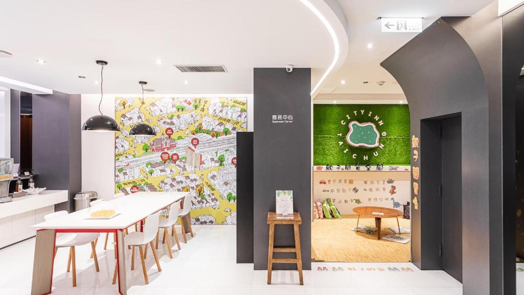 a kitchen and dining room with a large mural on the wall at CityInn Hotel Plus - Taichung Station Branch in Taichung