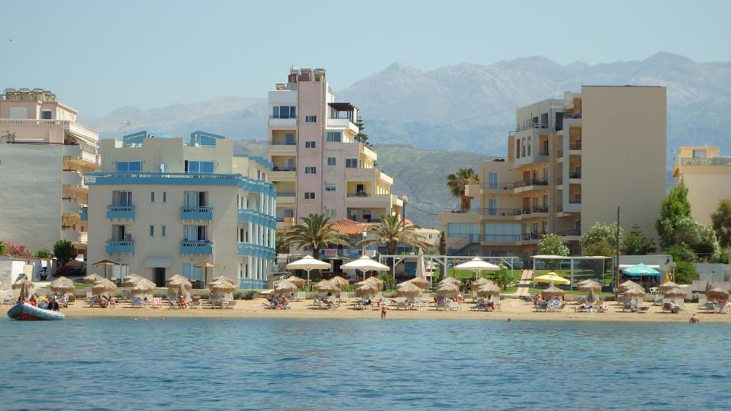 a large body of water with houses and buildings at Hotel Christina in Chania