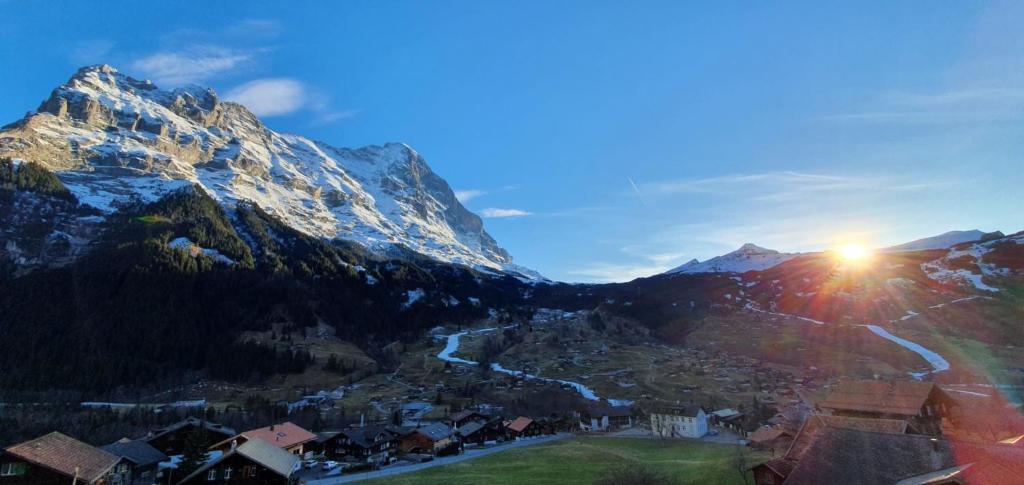 a view of a mountain with the sun shining on it at Bel-Air Eden in Grindelwald