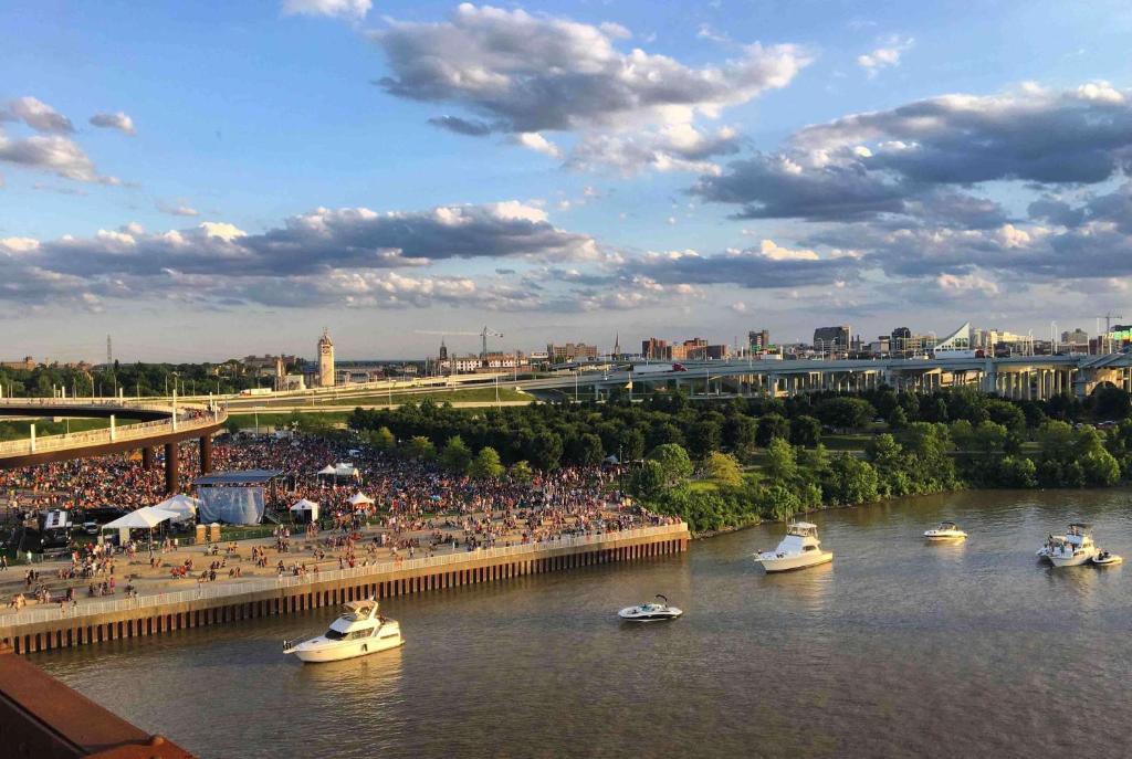 a group of boats in a river with a crowd of people at Galt House Hotel, A Trademark Collection Hotel in Louisville