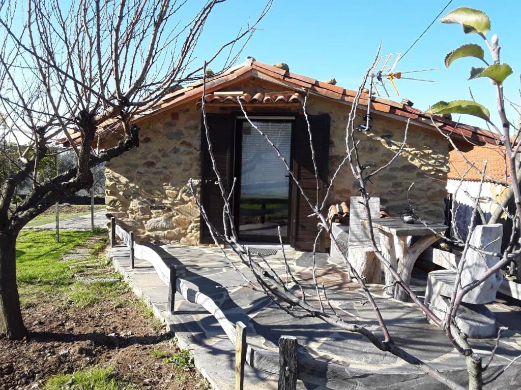 ein Steinhaus mit einem Zaun davor in der Unterkunft A casa do Moinho in Pedrógão Pequeno