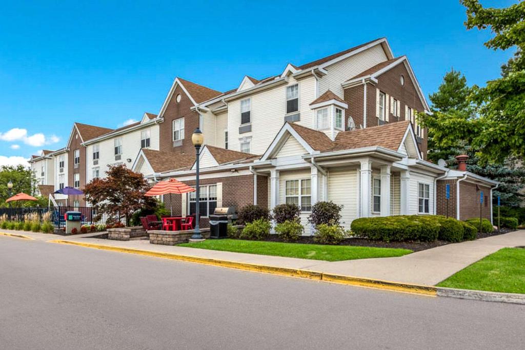 a large house on the side of a street at Birch Hills Suites - Blue Ash in Blue Ash