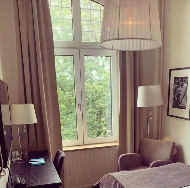 Säng eller sängar i ett rum på Clarion Collection Hotel Norre Park