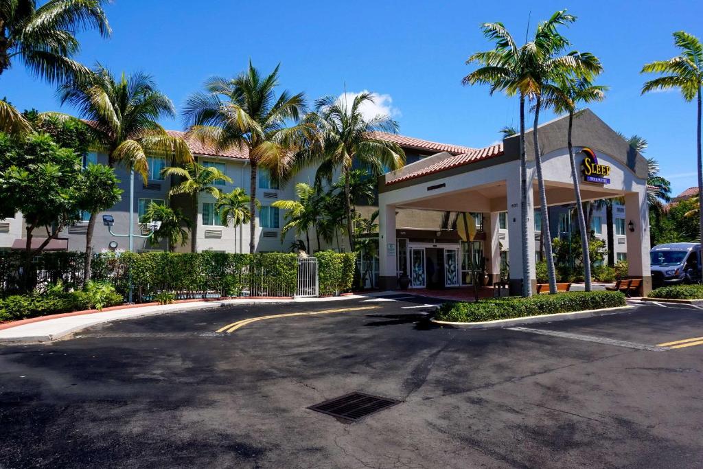 a gas station with palm trees in front of it at Sleep Inn & Suites Dania Beach in Dania Beach