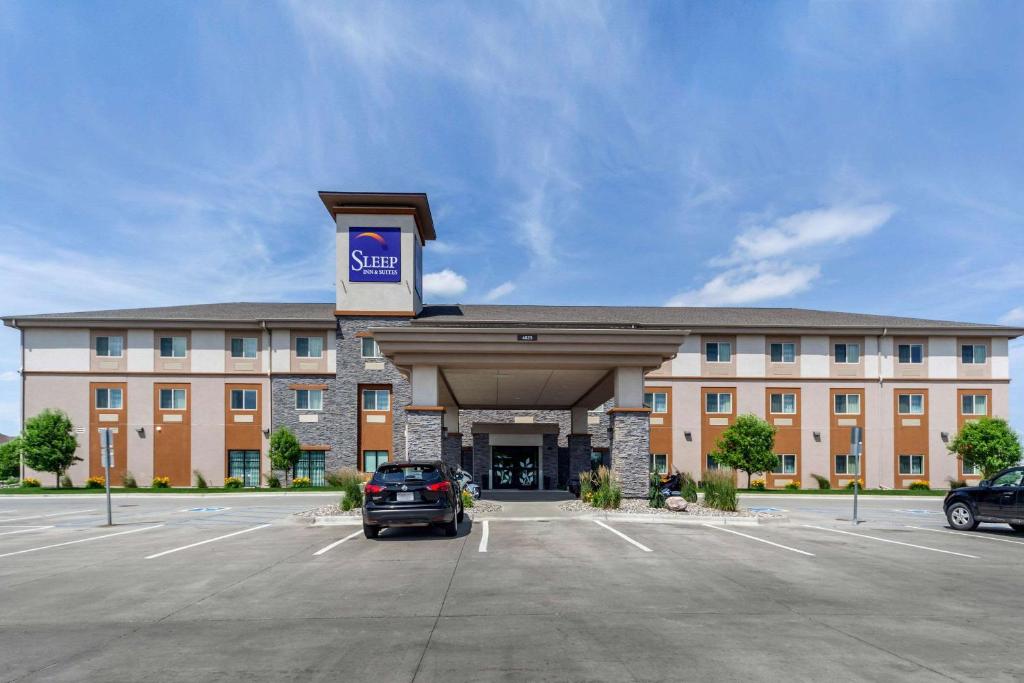 a large building with a car parked in a parking lot at Sleep Inn & Suites Fargo Medical Center in Fargo