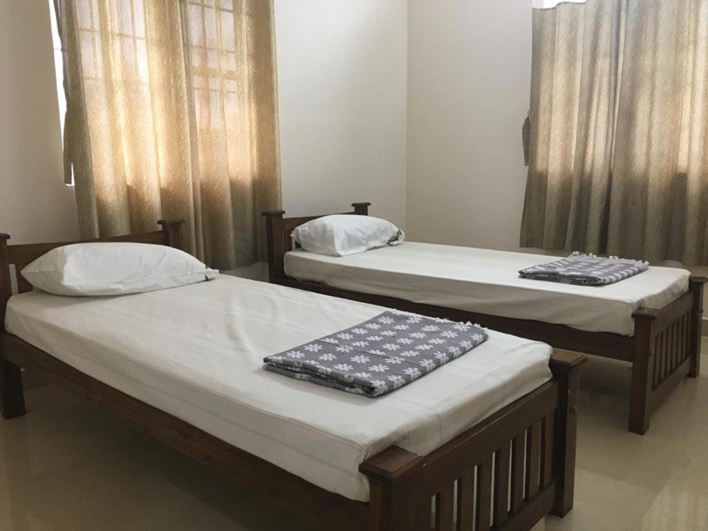 Postel nebo postele na pokoji v ubytování Shantham Service Apartments, Kinathukadavu, Coimbatore