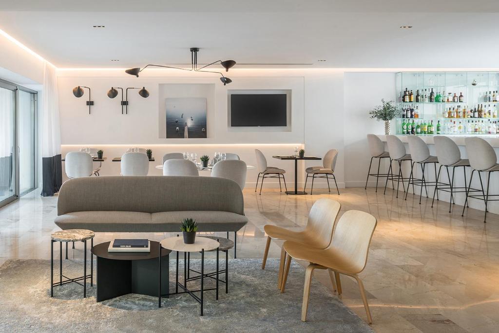 
a living room filled with furniture and a table at Amarilia Hotel in Athens
