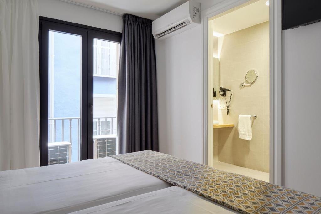 Postel nebo postele na pokoji v ubytování Hostal Arriazu