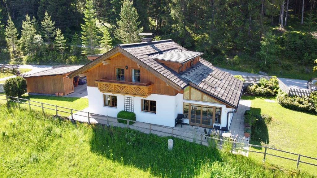 a house on top of a grassy hill at Ferienhaus Altenmarktblick in Altenmarkt im Pongau