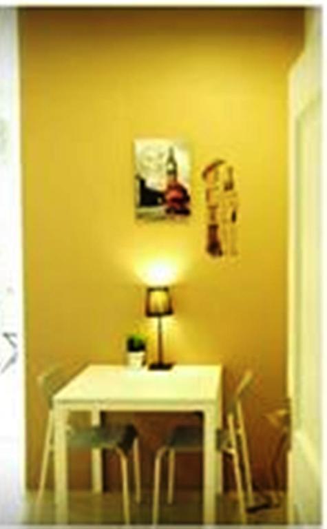 A small writing desk and two chairs occupy a warmly lit alcove.