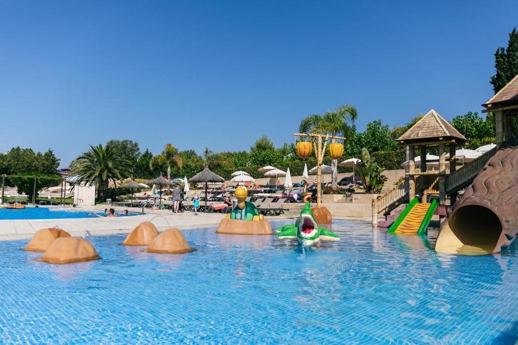 a pool with a water park with people playing in it at Camping Tucan - Mobile Homes by Lifestyle Holidays in Lloret de Mar