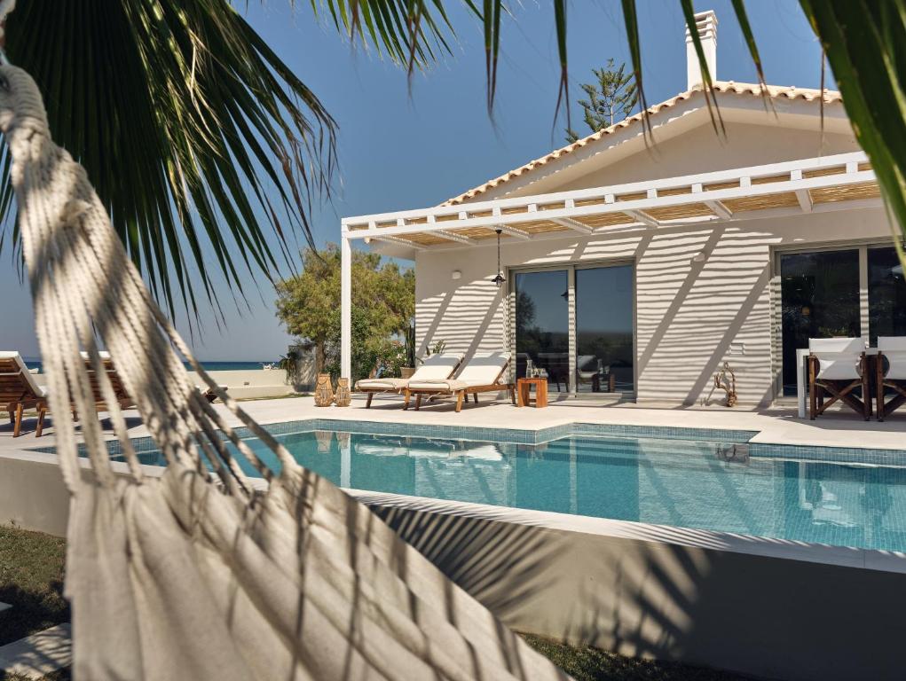 The swimming pool at or close to Astarte Villas - Onda Del Mar Beach Villa