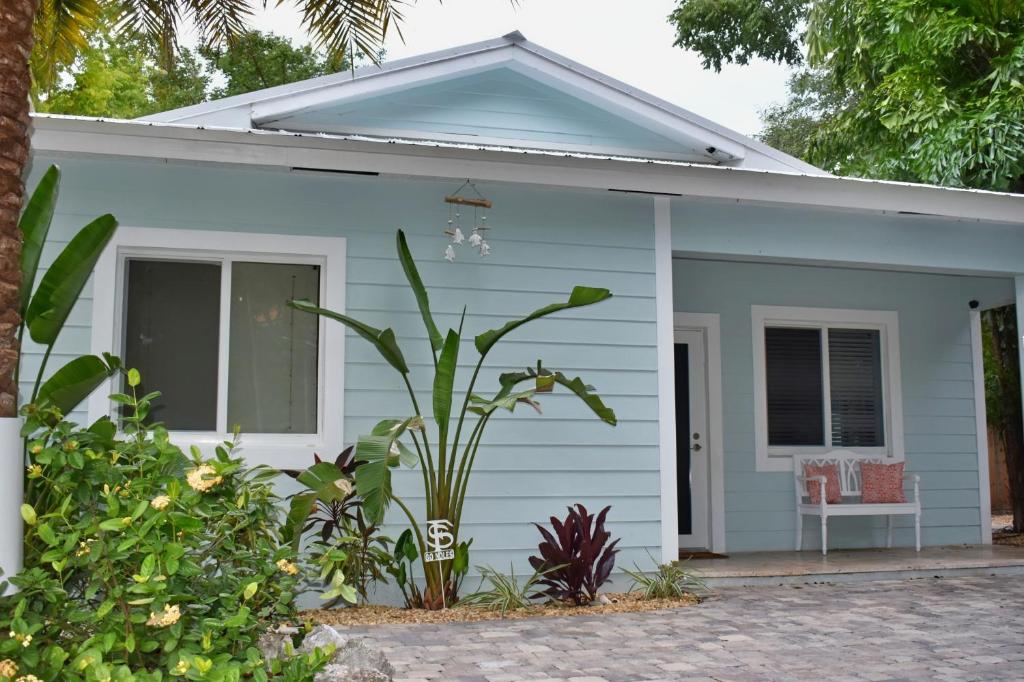 a blue house with a chair in front of it at Indian Mound in Tavernier