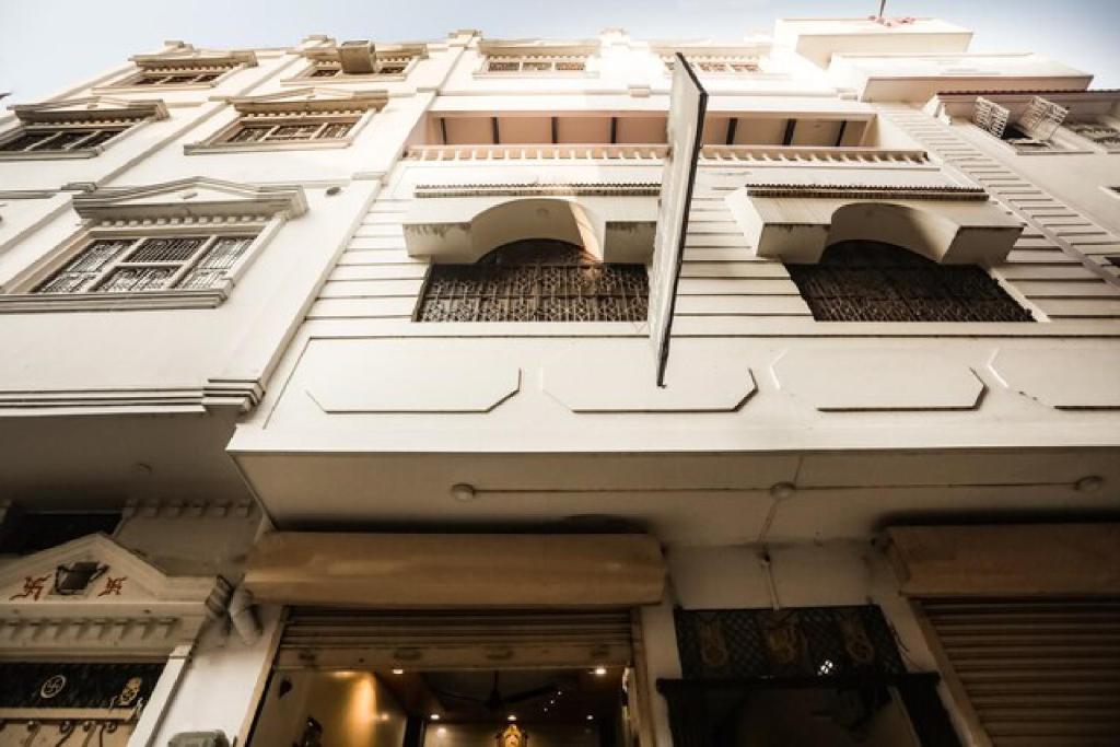 a white building with a flag on the side of it at Hotel Aakash Ganga in Varanasi