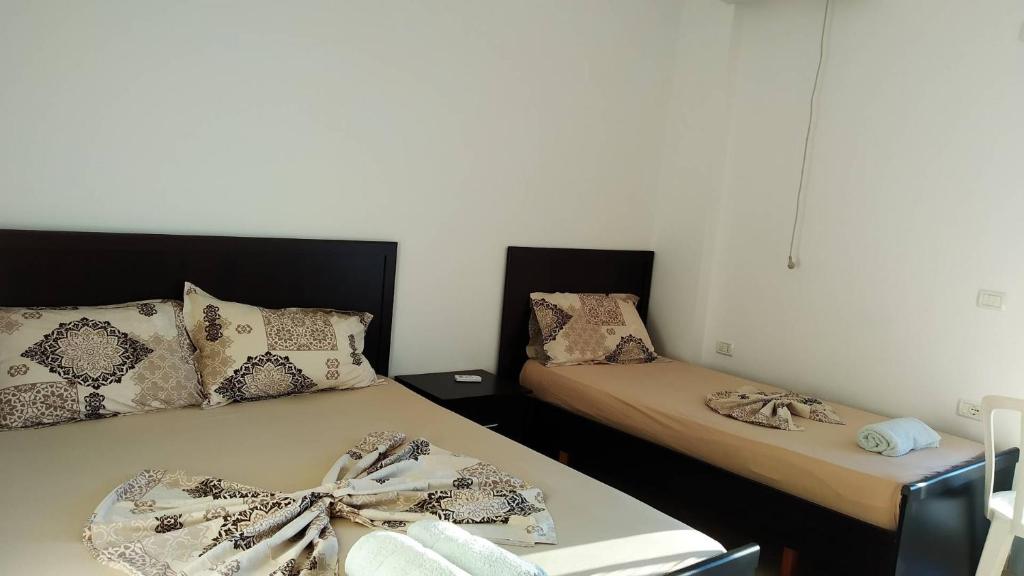two beds sitting next to each other in a room at Vila Llaka in Himare