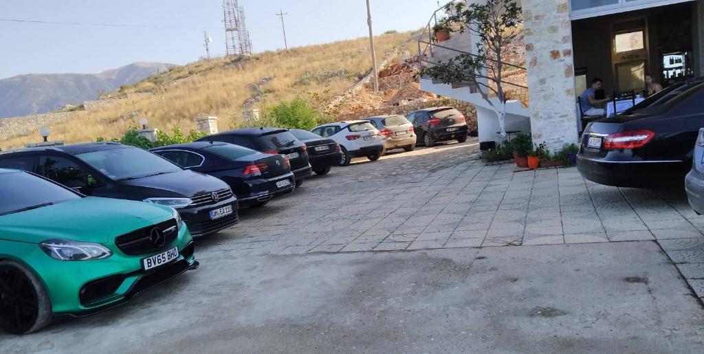a row of cars parked in a parking lot at Vila Llaka in Himare