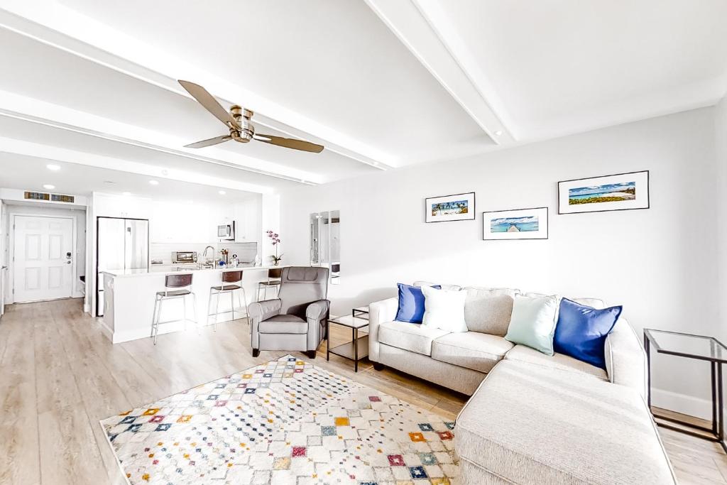 a white living room with a couch and a table at Ocean Sands 1105 in St. Pete Beach