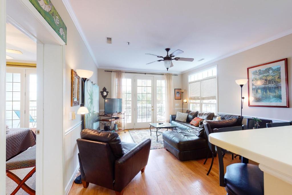 a living room with a couch and a table at Pavilion Watch #1A in Folly Beach