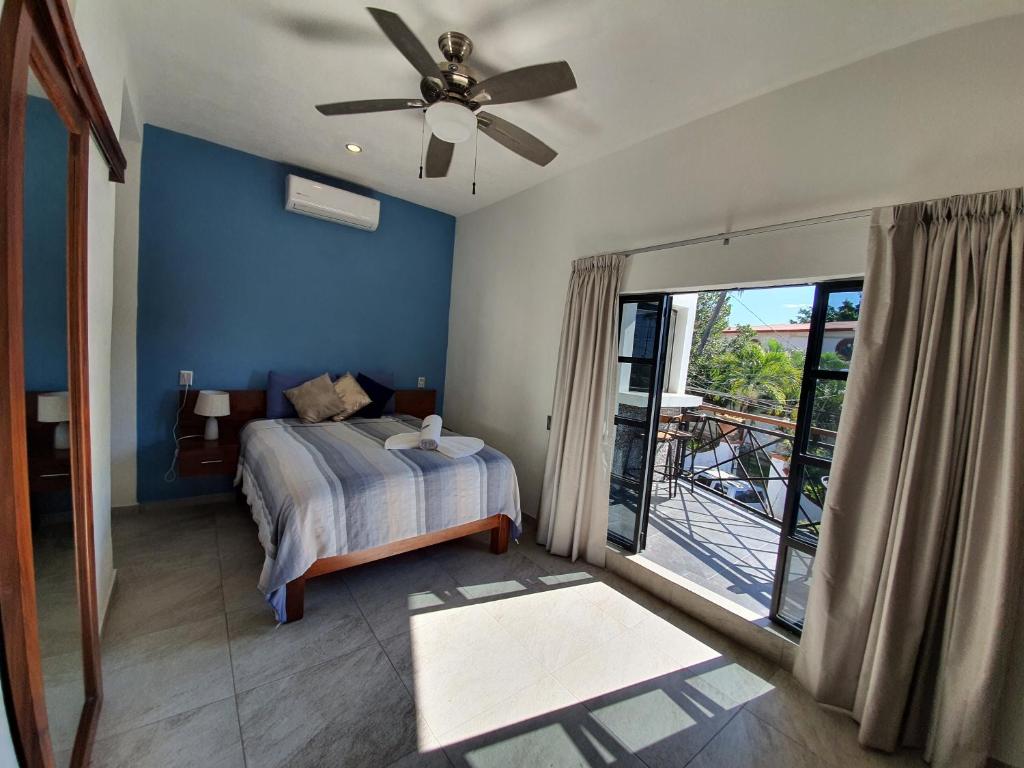 a bedroom with a bed and a ceiling fan at HOTEL OLAS ALTAS BUCERIAS in Bucerías